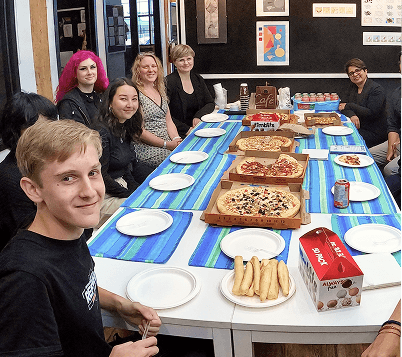Students enjoying pizza at a social gathering